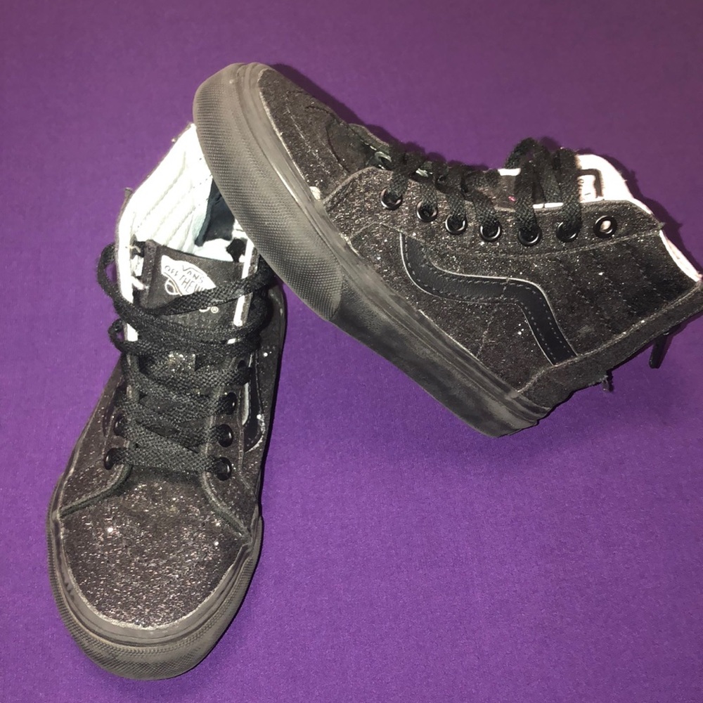 Girls black glitter high top vans.